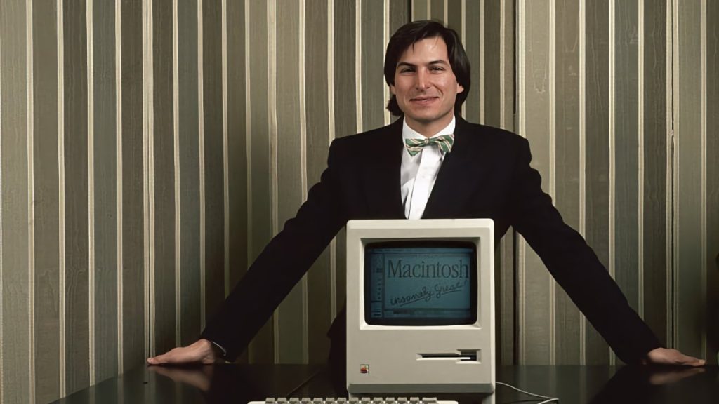 Image of Steve Jobs in front of a computer