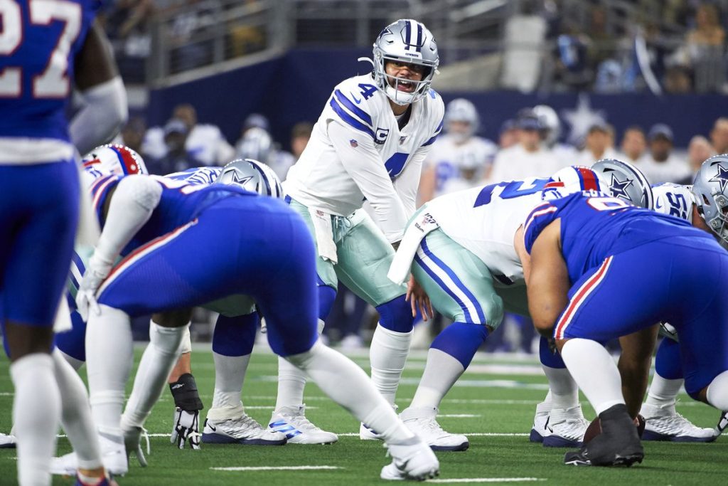 men wearing football jerseys playing football